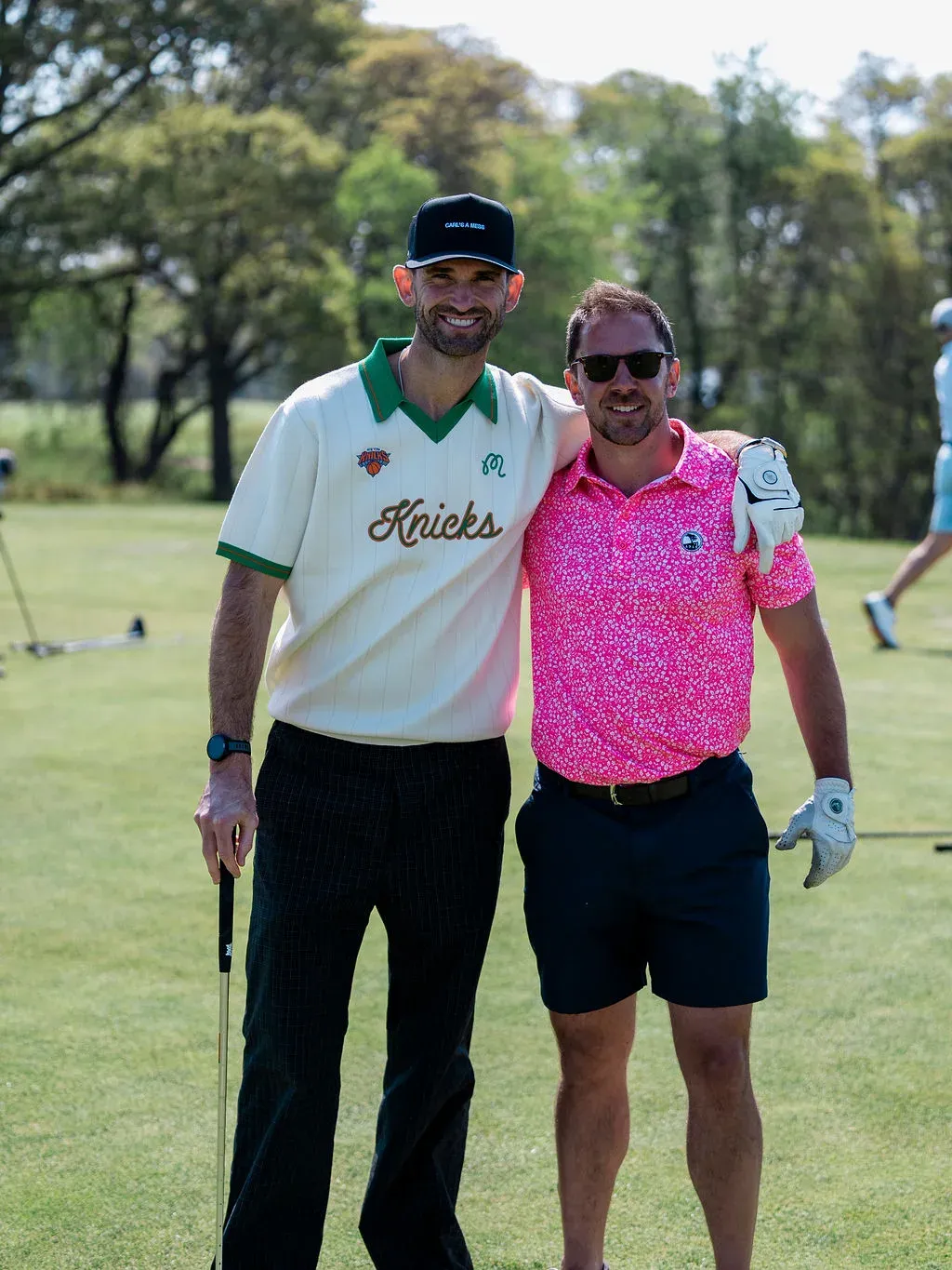 Two golfers on the course at the Blue & Gold Classic