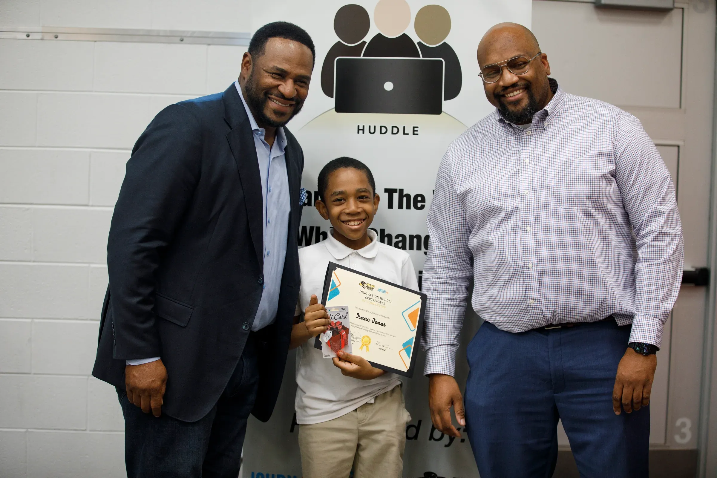 A student honored at a foundation ceremony with Jerome Bettis